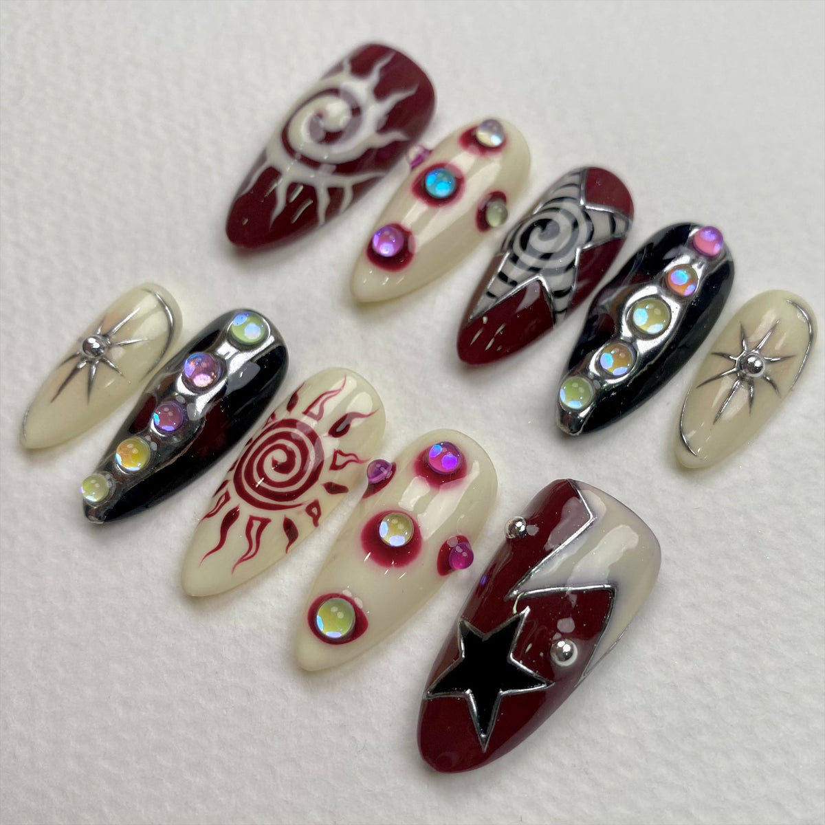 Celestial Chaos Press-On Nails – Burgundy Cream Fake Nails with Sun, Stars & Swirl Designs