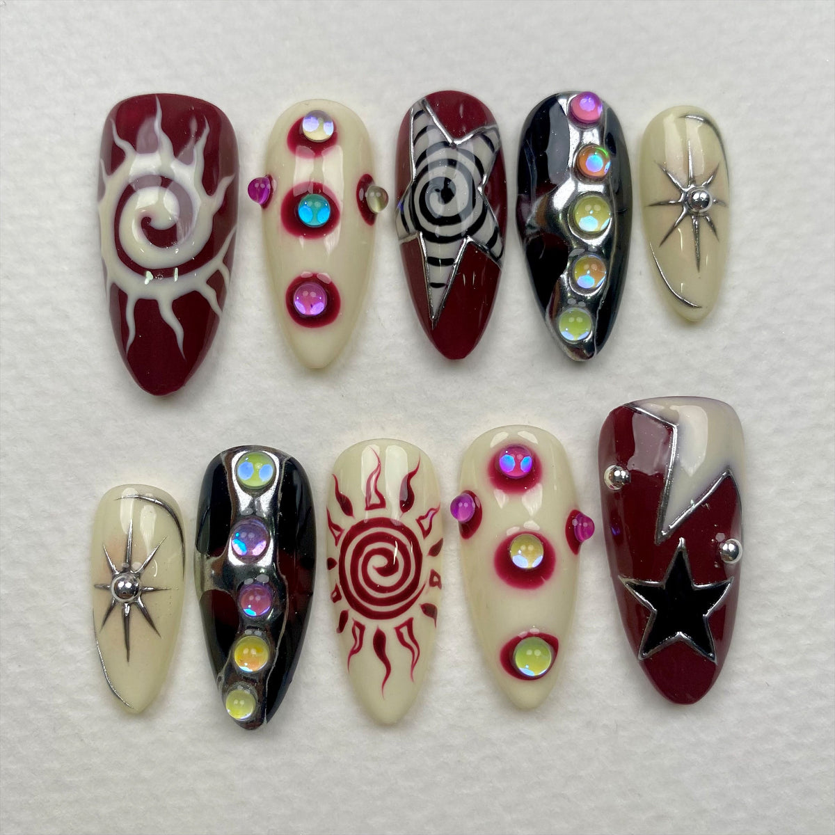Celestial Chaos Press-On Nails – Burgundy Cream Fake Nails with Sun, Stars & Swirl Designs